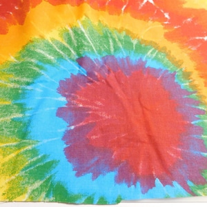 May include: A colorful tie-dye fabric with a swirling pattern of red, orange, yellow, green, blue, and purple.