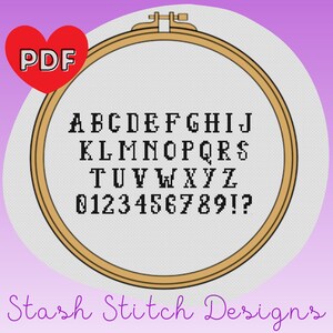 May include: A PDF pattern for cross-stitch embroidery featuring the alphabet and numbers in a black font on a white background. The pattern is displayed in a wooden embroidery hoop.