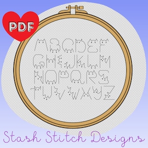 May include: A PDF cross stitch pattern featuring the alphabet in the shape of cats. The pattern is displayed in a wooden embroidery hoop on a white background. The text "Stash Stitch Designs" is written in purple below the hoop.