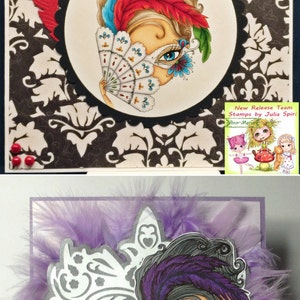 May include: Two handmade cards featuring a woman with a mask and a fan. The first card has a black and white damask pattern background with a red, blue, and green feather design. The second card has a purple feather background with a silver and white mask design. Both cards feature the text "Lori Thomas" and "LoriThomasBlog.Blogspot.co.UK".