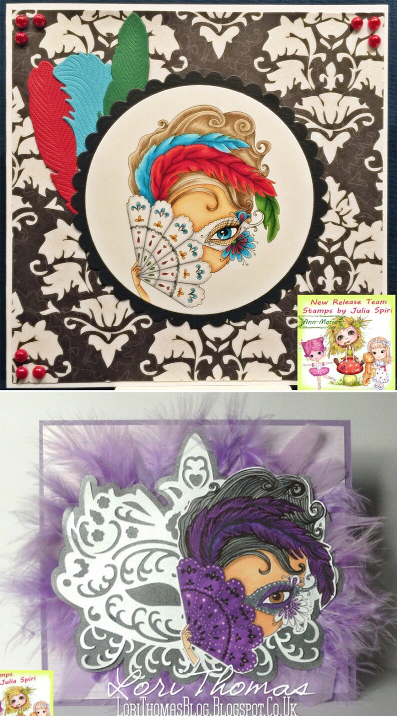 May include: Two handmade cards featuring a woman with a mask and a fan. The first card has a black and white damask pattern background with a red, blue, and green feather design. The second card has a purple feather background with a silver and white mask design. Both cards feature the text "Lori Thomas" and "LoriThomasBlog.Blogspot.co.UK".