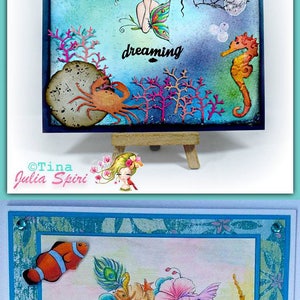 May include: Two handmade greeting cards featuring a whimsical illustration of a girl with a crown of flowers and fish. The first card has a blue background with the text "dreaming" and the second card has a pink background with the text "Happy Birthday!"