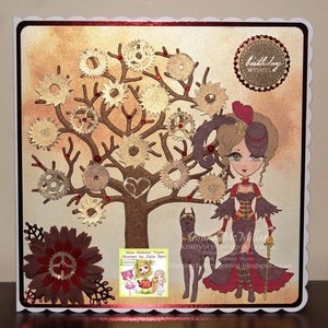 May include: A handmade card with a steampunk theme. The card features a brown tree with gold gears, a woman in a brown dress and a black hat, and a black dog. The card has a red and gold border and the text "birthday wishes" in a gold circle.