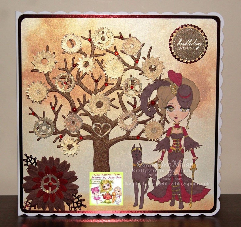 May include: A handmade card with a steampunk theme. The card features a brown tree with gold gears, a woman in a brown dress and a black hat, and a black dog. The card has a red and gold border and the text "birthday wishes" in a gold circle.