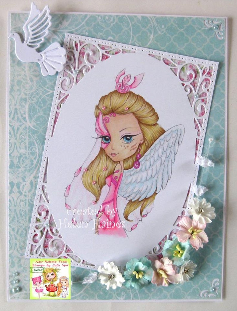 May include: A white card with a decorative border and a pink and white illustration of a fairy with wings. The card has the text "created by Helen Haines" at the bottom.
