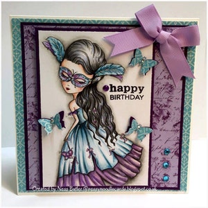 May include: A purple and blue birthday card with a masked girl in a purple and blue dress. The card has a purple bow and butterflies. The text "happy birthday" is written on the card.