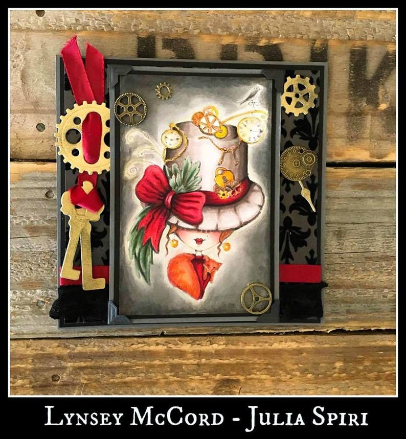 May include: A handmade card with a steampunk theme featuring a girl with a top hat, a red bow, and a cat. The card is decorated with gears, keys, and other embellishments.