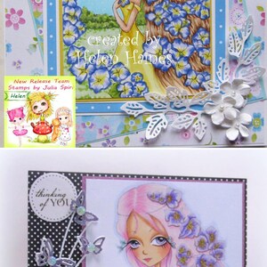 May include: Two handmade greeting cards featuring illustrations of fairies with flowers in their hair. The top card has a blue background and the bottom card has a black and white polka dot background. Both cards have the text "thinking of you" on them.