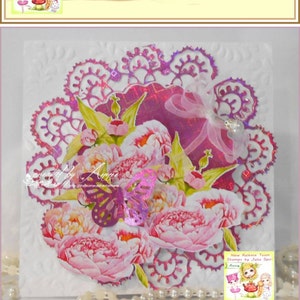 May include: A wedding card with a floral design and the text "With Love on your Wedding Day". The card is decorated with a white lace border and a white satin ribbon.