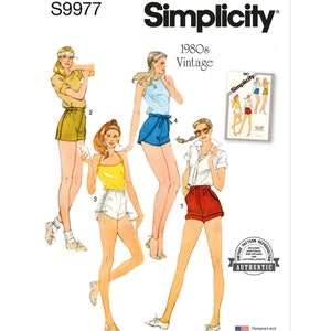 May include: Vintage Simplicity sewing pattern S9977 for 1980s shorts. The pattern includes four different styles of shorts, with a variety of colors and fabrics.