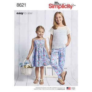 May include: A sewing pattern for two girls' dresses. The pattern is for a sleeveless dress with a floral print and a short-sleeved top with a lace overlay. The pattern is from Simplicity and is easy to sew.