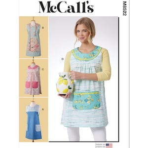 May include: McCall's sewing pattern M8522 for a sleeveless apron with a gathered neckline and a pocket. The apron is shown in three different fabrics: a blue and white gingham, a pink floral print, and a blue and white striped fabric with a lemon print. The pattern includes instructions for making the apron in sizes XS-XL.
