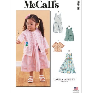 May include: McCall's M8416 sewing pattern for children's clothing featuring a pink and white gingham dress, a floral print dress, a striped overall, a solid green overall, and a floral print shirt.  The pattern is designed and printed in the USA.  Laura Ashley since 1953.