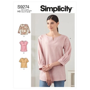 May include: Simplicity sewing pattern S9274 for a women's top with a V-neck and long sleeves. The pattern includes three different styles: a floral print top, a solid pink top, and a striped top.