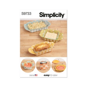 May include: A sewing pattern for making fabric covers for various kitchen dishes. The pattern includes instructions for making covers for a casserole dish, a loaf pan, a bowl, and a mug. The pattern is from Simplicity and has the number S9733 printed on it.