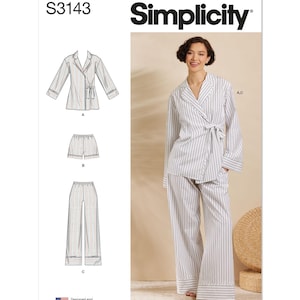 May include: Simplicity pattern S3143 for a pajama set. The pattern includes a long-sleeved wrap top with a tie, shorts, and wide-leg pants. The pajamas are white with vertical blue stripes. The image also shows a woman wearing the pajama set.