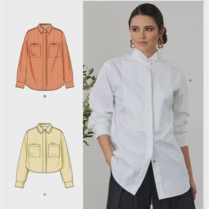 May include: Simplicity sewing pattern S3232. The image shows a woman wearing a white button-down shirt and illustrations of two other shirt designs. One is orange and white striped, the other is a cropped yellow shirt. The text "Designed and printed in USA" is also visible.