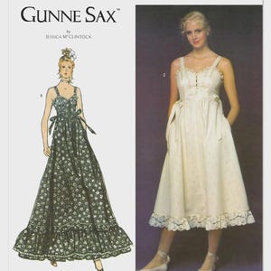 May include: Simplicity pattern S3287 for a Gunne Sax by Jessica McClintock dress. The package displays a dark green floral print dress and a solid cream-colored dress, both featuring spaghetti straps, a fitted bodice, and a ruffled hemline.