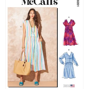 May include: McCall's sewing pattern for a dress with three different styles. The pattern is for a sleeveless dress with a V-neck and a gathered skirt, a short-sleeved dress with a V-neck and a gathered skirt, and a long-sleeved dress with a V-neck and a gathered skirt. The pattern is designed and printed in the USA.