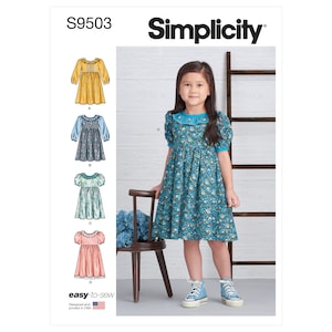 May include: Simplicity sewing pattern S9503 for a girl's dress. The pattern includes four different styles: a yellow dress with puffed sleeves, a blue dress with puffed sleeves, a floral print dress with short sleeves, and a pink gingham dress with short sleeves. The pattern is labeled "easy-to-sew" and is designed and printed in the USA.