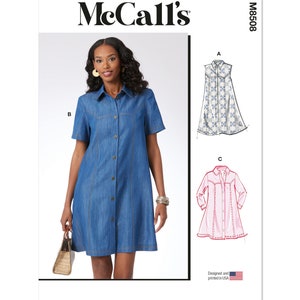 May include: McCall's sewing pattern M8508 for a button-front dress with short sleeves. The pattern includes three variations: a sleeveless dress with a floral print, a short-sleeved denim dress, and a long-sleeved dress with a striped print. The pattern is designed and printed in the USA.