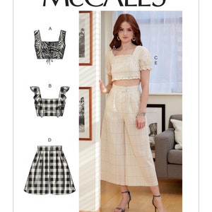 May include: McCall's sewing pattern M7962 for a cropped top and wide-leg pants. The pattern includes four different views: a cropped top with a square neckline and tie detail, a cropped top with ruffles, wide-leg pants, and shorts. The model is wearing the cropped top with a square neckline and wide-leg pants.