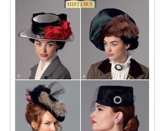 May include: A vintage sewing pattern for four different styles of hats. The pattern is from Butterick and is labeled "Making History." The hats are a silver and black hat with a red flower, a black and green hat with a feather, a black hat with a veil, and a black hat with a veil and a brooch.