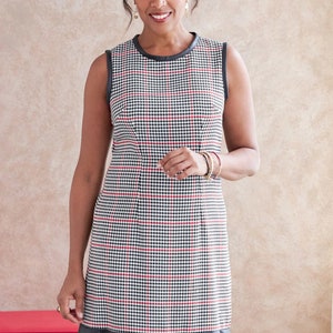 May include: A sleeveless dress with a black and white houndstooth pattern and red accents. The dress has a black faux leather trim and a ruffled hem.