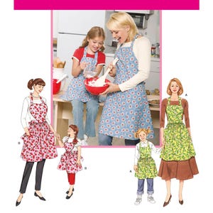 May include: Simplicity sewing pattern 3949 featuring aprons in various styles. The image shows a mother and daughter baking, wearing blue aprons with white floral patterns. Other aprons have cherry and floral designs.
