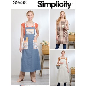 May include: A sewing pattern for three different styles of aprons. The pattern is called Simplicity S9938 and is labeled "easy-to-sew". The aprons are shown on three models wearing different styles of clothing. The first apron is a brown and white checkered apron with a single pocket. The second apron is a white apron with a single pocket and a brown stripe. The third apron is a blue and white checkered apron with two pockets and a floral print on the pockets.