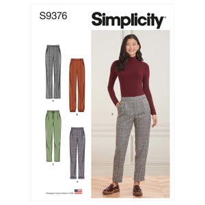 May include: Simplicity sewing pattern S9376 for pants. The pattern includes four different styles of pants: A - straight leg pants, B - cuffed pants, C - drawstring pants, and D - pleated pants. The model is wearing the pleated pants, which are a plaid pattern.