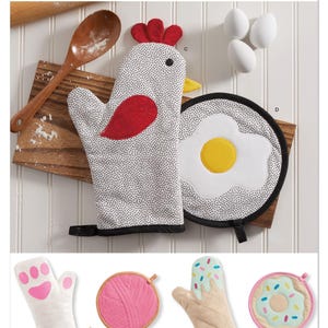 May include: Simplicity sewing pattern S3260 featuring oven mitts and pot holders. The main design is a chicken-shaped oven mitt with a red wattle and comb. Other designs include a paw print, yarn, ice cream cone, and donut. Designed and printed in the USA.