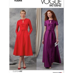 May include: Vogue Patterns sewing pattern V2044 for a dress with a keyhole neckline and bow detail. The pattern includes two variations: a short-sleeved dress and a long-sleeved dress. The dress is shown in red and purple.