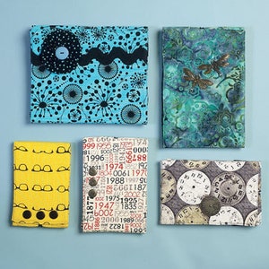 May include: Five different fabric covered wallets with various patterns and designs. The wallets are all rectangular and have a button closure. The patterns include a blue and black design with circles, a green and blue design with a floral pattern, a yellow design with eyeglasses, a white and red design with numbers, and a gray design with clock faces.