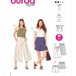 May include: A Burda Style sewing pattern, number 6138, featuring two women modeling different pants and skirt designs. The pattern includes sizes EUR 34-44 and US 8-18. The text "STEP BY STEP" is also visible.