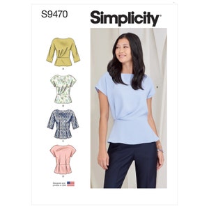 May include: Simplicity sewing pattern S9470 for a women's top with a gathered waist. The pattern includes four different views: a yellow top, a floral print top, a blue and white patterned top, and a pink top. The pattern is designed and printed in the USA.