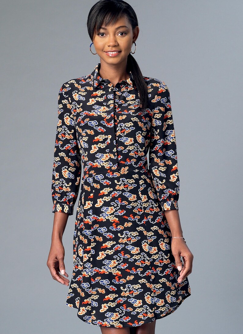 May include: Black dress with a colorful cloud pattern. The dress has a collared neckline, long sleeves, and a button-down front. The dress is knee-length and has a fitted waist. The cloud pattern includes orange, yellow, and blue accents.