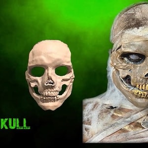 May include: A close-up of a realistic skull mask with a detailed bone structure and a toothy grin. The mask is made of a smooth, light-colored material. The word "SKULL" is written in green letters below the mask.