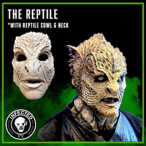 May include: A close-up of a detailed, realistic reptile mask with a textured, scaly surface. The mask is painted in shades of brown, green, and yellow. The mask has a wide, open mouth with sharp teeth. The text "THE REPTILE *WITH REPTILE COWL & NECK" is visible at the top of the image.