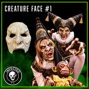 May include: A Halloween-themed image featuring a creature mask and two people in elaborate costumes with menacing makeup. The mask is off-white with a wrinkled texture. The costumes include black and gold accents, and the text "CREATURE FACE #1" is visible.
