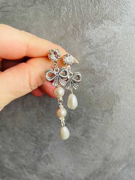 Swarovski bow earrings discount