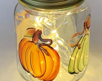 Painted mason jar with pumpkins lighted with string light, 16 oz.