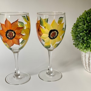 Set of 2 handpainted wine glasses with orange and yellow sunflowers, always a classic, great gift idea! They are 10 1/2 oz , for white wine.