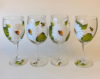 Painted wine glasses with daisies and bees. Listing is for one glass.