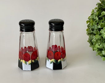 Painted salt and pepper shakers with  black and white stripes red roses design, 3 oz tall, black painted tops.