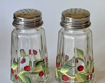 Hand painted  glass salt and pepper shakers with holly berry design.