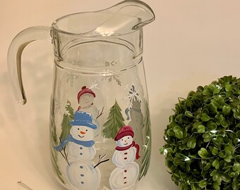 Painted pitcher with snowman and family.