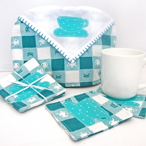 May include: Set of four teal and white checkered fabric coasters with a teal teacup design. A matching teal and white checkered fabric teapot cozy with a teal teacup design is also included.