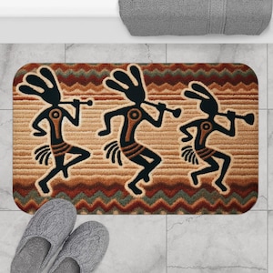 May include: A brown and beige bath mat with a repeating pattern of stylized figures playing musical instruments. The figures are black and have a geometric design. The background is a brown and beige chevron pattern.