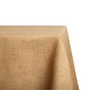 May include: A close-up of a brown burlap tablecloth. The fabric has a woven texture and a slightly rough feel.
